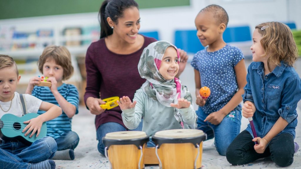 adult with children playing with instruments